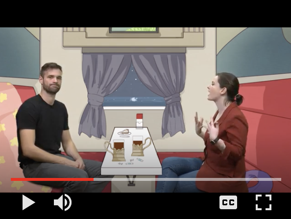 An image of a video of Molly and a fellow TA for the class at the green screen appearing on this same train