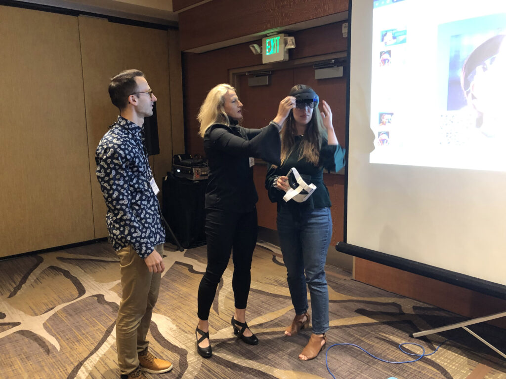 Picture 2 - Kevin Papin, Regina Kaplan-Rakowski, and Tricia Thrasher comparing Microsoft’s HoloLens and Meta’s Quest 2 VR headsets before their presentation on Virtual Reality 