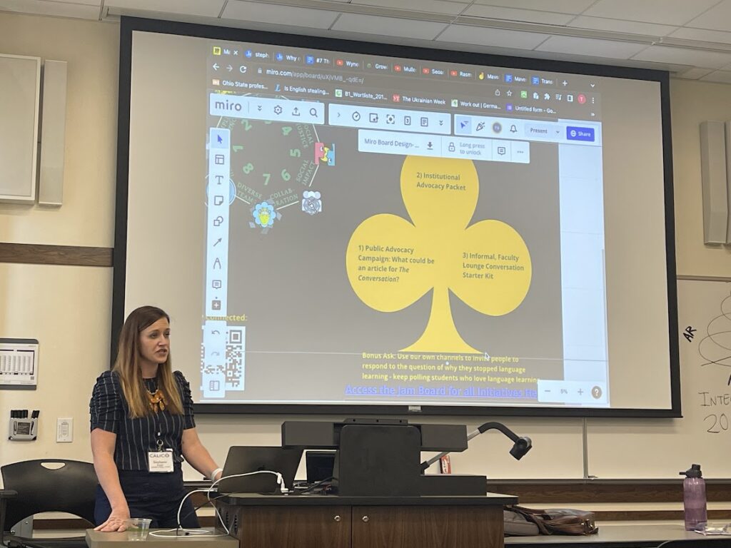 Picture 2 - Stephanie Knight, from the University of Oregon’s CASLS, presenting “Mavericks of the Mind” - Slide says: 1. Public Advocacy Campaign; 2. Institutional Advocacy Packet; 3. Informal, Faculty lounge communication starter kit