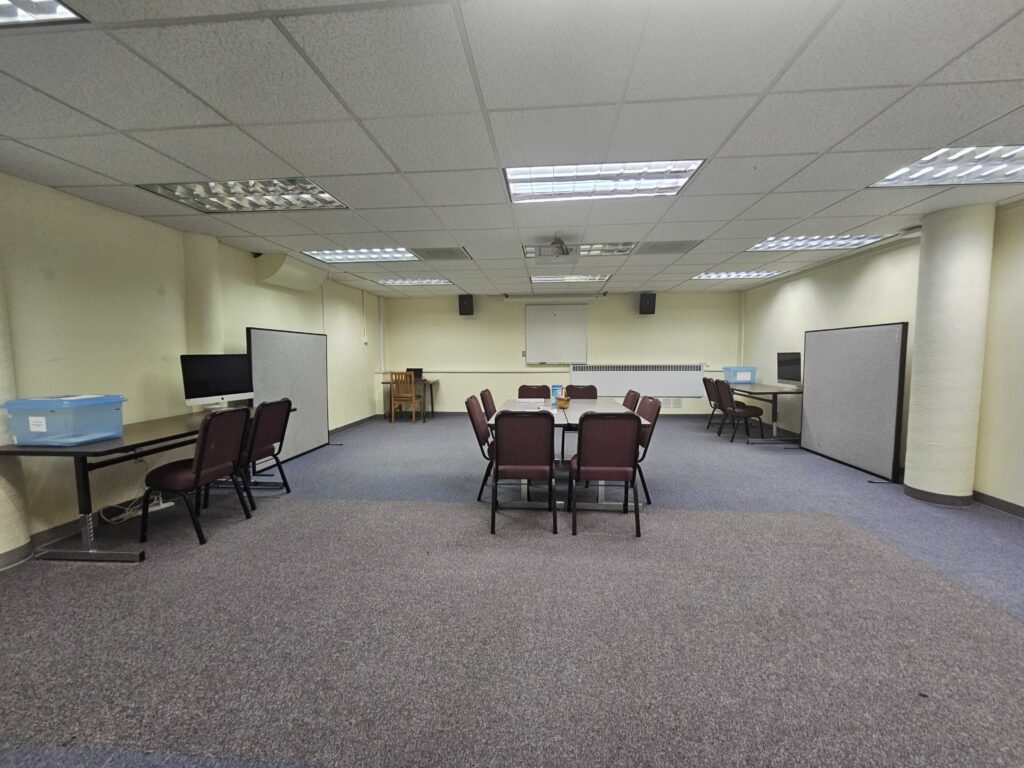 Picture 1 - Our Staging Area - a mostly empty room with several tables that have chairs at them