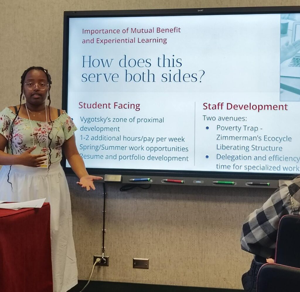 Picture 8 -  Abigail Haile presents about Fostering Student Engagement in Language Centers; Photo credit: Ayesha Swinton - projector screen says: Importance of mutual benefit and experiential learning: how does this serve both sides? student facing, staff development