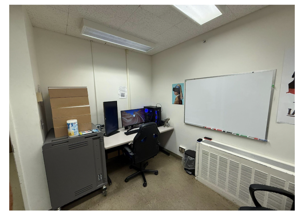Picture 6 - Computer and Storage Area - has a desk with a computer, some storage space, and a whiteboard on the wall