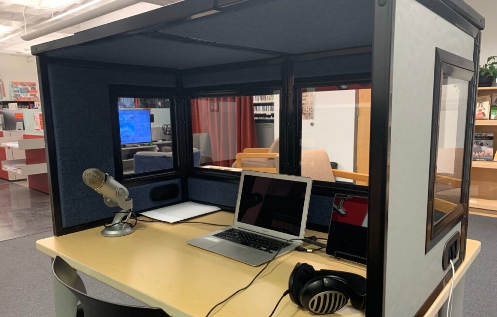 Portable Interpretation Booth Used at Iowa State University - has a microphone, laptop, headphones, and walls to make a booth