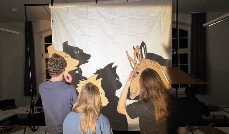 students performing the Bremen musicians with shadow theater