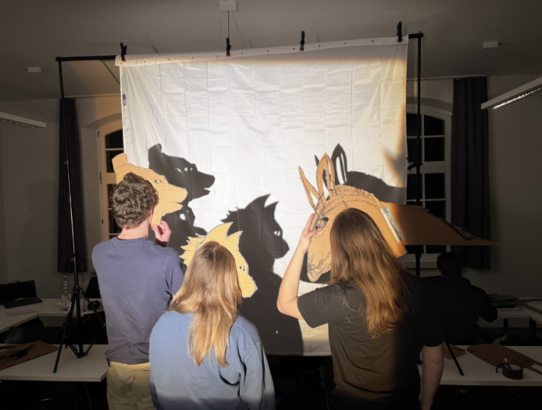 students performing the Bremen musicians with shadow theater