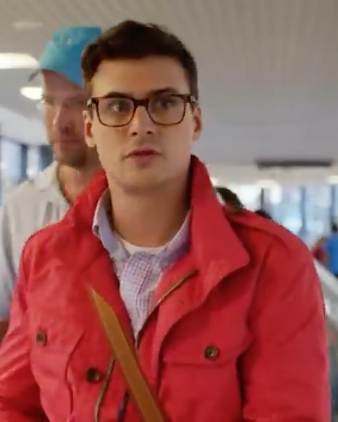 a man in glasses and a red jacket